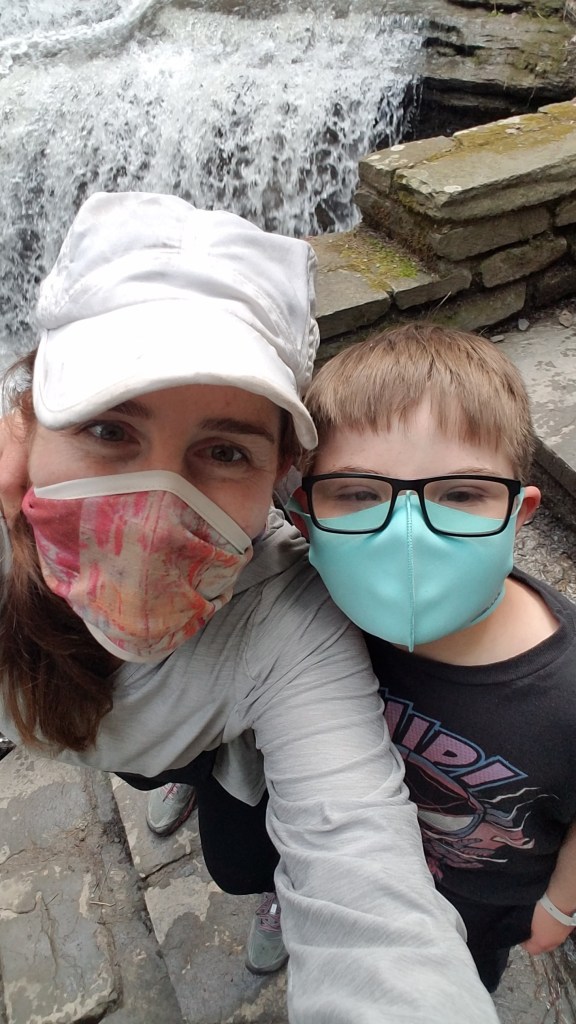 Mother and son smiling under their masks